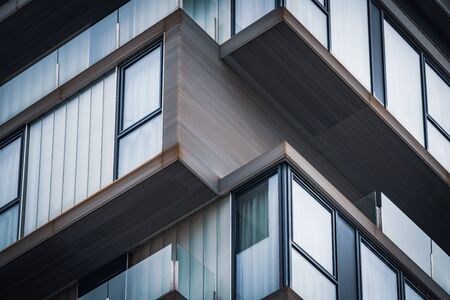 Architecture detail of the glass balconies of a minimalist urban buildingの写真素材
