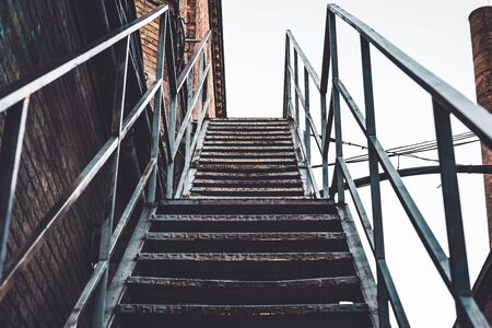 Exterior rusty stairs of an old abandoned textile factoryの写真素材