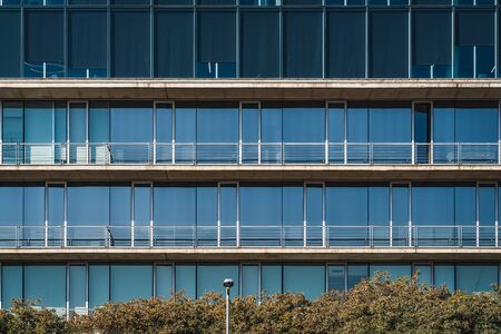 Minimalist architecture of the glass and concrete facade of an urban buildingの写真素材
