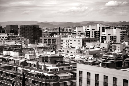 Cityscape of the roofs of several residential buildings of Barcelona in black and whiteの写真素材