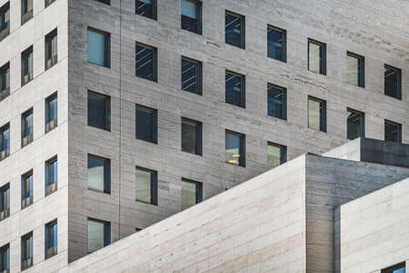 Geometric facades of an office building built in roman travertine marbleの写真素材