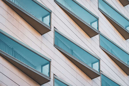 Eclectic glazed windows of a modern urban buildingの写真素材