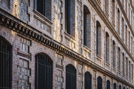 Rows of windows of an old restored industrial factoryの写真素材