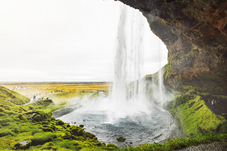 Looking at the waterfall from under the rock - Icelandの写真素材