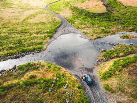 Car standing in front of a flooded road somewhere in mainland Iceland