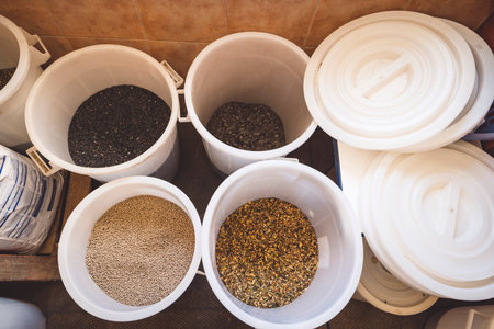 A look inside buckets full of grain for horses to eatの写真素材