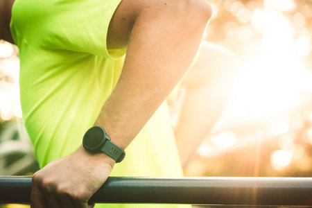 Sun flare, man with smart watch on the wrist working out outside