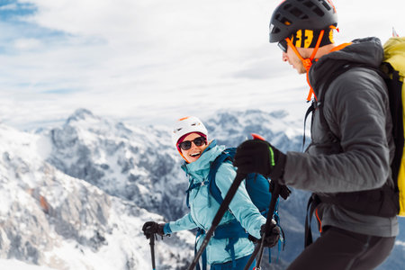 Waist up smiling couple of mountaineers ski touring in the snowy Alpsの写真素材