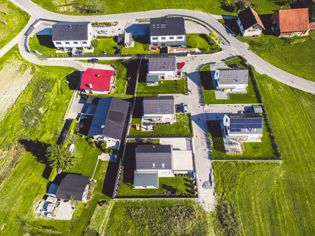 Arial view of newly developed housing community surrounded by green fieldsの写真素材