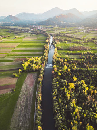 Vertical photo of a river running trough the country side with suburban communities scattered all acrossの写真素材