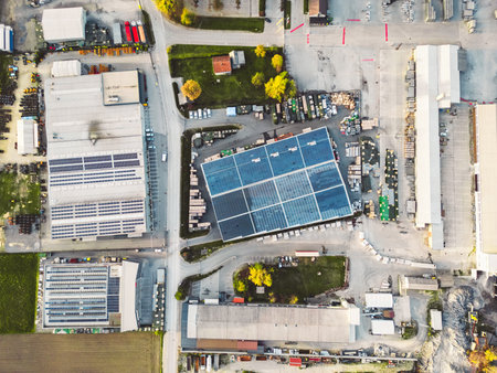 Birdseye view of industrial area with a large warehouses, solar panels on the roof topsの写真素材