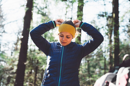 Caucasian woman mountaineer getting ready at the carの写真素材