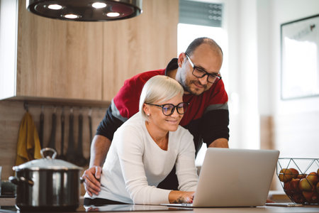 Loving couple working from home on their business together, working in the kitchenの写真素材