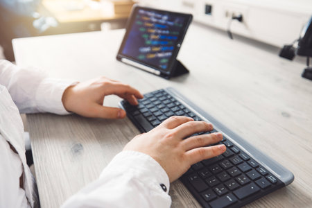 Close up unrecognizable man, programmer typing on a keyboardの写真素材