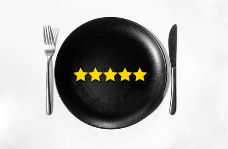 Five Star Food Rating Concept Background in a black and clean restaurant plate. Rate the restaurant or food backdrop conceptの写真素材