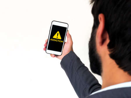 Social Media and Selfie Addiction Concept Background with Warning sign inside mobile screen. Mobile...