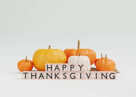 Happy Thanksgiving concept with pumpkins and wooden cubes on white background.の写真素材