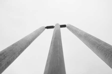 Low angle view of two steel pillars against white sky. Black and white photo.の写真素材