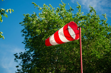 Windsock against the sky and foliage
