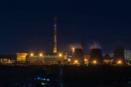 View of the working plant with pipes and yellow lights at night