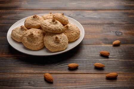 Almond biscuits on a plate on a wooden tableの写真素材