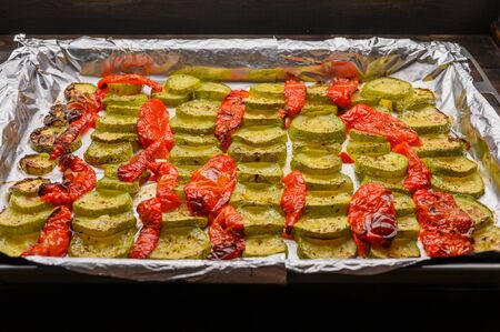 Homemade slices of bubbly and peppers baked on foil in the oven. Close upの写真素材