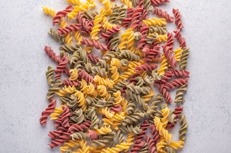 Multicolored pasta background concept on gray background. Diet and healthy food conceptの写真素材