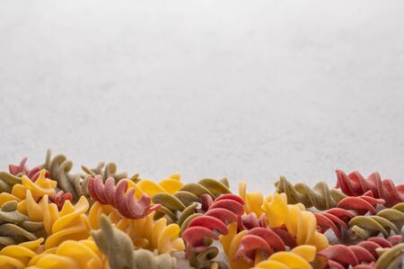 Multicolored pasta background concept on gray background. Diet and healthy food concept. Italian cuisine concept with copy space for your textの写真素材