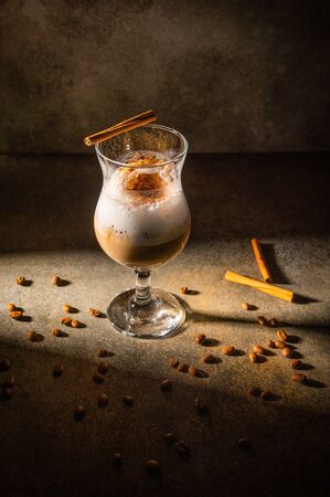 Homemade dalgona coffee. Trendy fluffy creamy whipped drink made by instant coffee, sugar and milk. Vertical orientationの写真素材