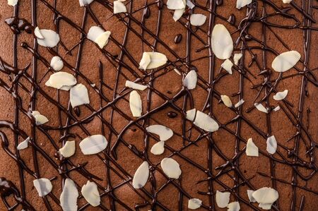 Brownie with chocolate and almond petals. Close up food background. Horizontal orientationの写真素材
