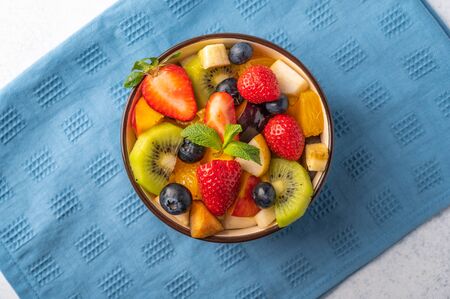 Fresh fruit salad with different ingredients on linen napkin. Healthy diet. Top viewの写真素材