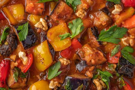 Homemade vegetable stew of eggplant, zucchini, tomatoes, peppers, prunes and greens. Close up food backgroundの写真素材