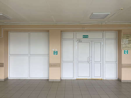 White plastic doors and stack panels in the hospital, copy space