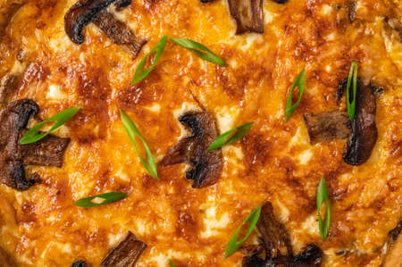 Food background of traditional French pie quiche with mushrooms, cheese and onionの写真素材