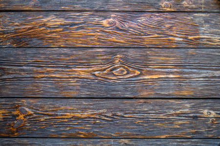 Background of old dark brown textural boards with knots, copy spaceの写真素材