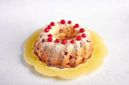 Homemade curd muffin with cranberries and orange zest in powdered sugar, selective focus, copy space, close upの写真素材