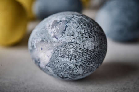Homemade Easter colored grey marble egg. Macro, selective focusの写真素材