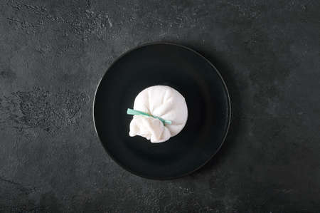 Traditional italian burrata cheese on dark plate on graphite background. Top view, copy spaceの写真素材