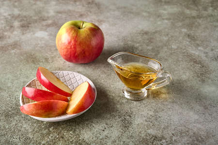 Apples slices on plate, apple fruit and juice on rustic wooden background. Close up. Selective focus