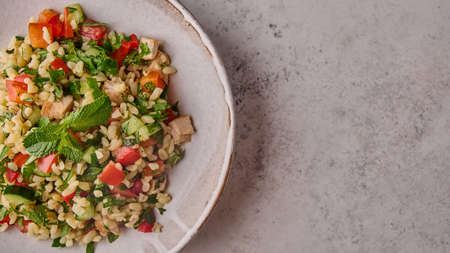 Panoramic view tabbouleh salad. Traditional Middle Eastern or Arabic dish with parsley, mint,...