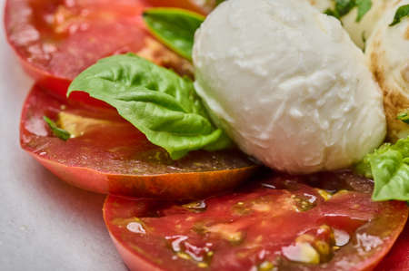Macro view tomatoes, basil and mozzarella cheese, selective focusの写真素材