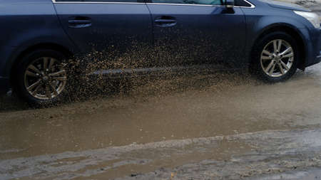 Splashing dirty water from a moving car