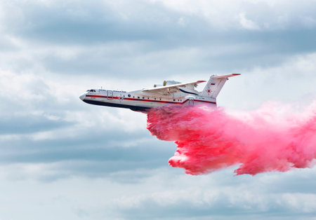 ZHUKOVSKY, RUSSIA - AUGUST 28, 2015: International aviation and space salon in Zhukovsky. Amphibian aircraft B200 flies and demonstrates the discharge of water when extinguishing the fireのeditorial素材
