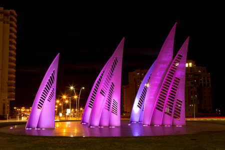 ASHDOD, ISRAEL - NOVEMBER 26, 2015: Sculptural group sail with changing colors at night in Ashdod, Israelのeditorial素材