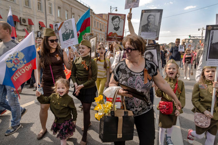 MOSCOW, RUSSIA - MAY 09, 2016: Procession of the public movement "Immortal regiment" in memory of the 26 million compatriots who died in the Great Patriotic War, children shout "Hurrah"のeditorial素材
