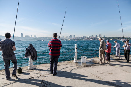 ISTANBUL, TURKEY - MAY 14, 2015: The fishermen on the shore of the Bosphorus in the early morning.のeditorial素材