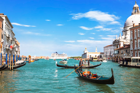 The Grand canal with views of the Cathedral Santa Maria della Salute and oceansky cruise liner on the horizon, Venice, Italyのeditorial素材