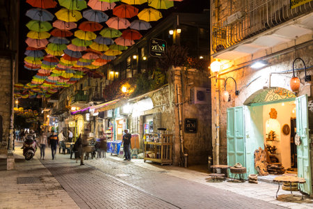 Night view of Yoel Moshe Salomon Street in Jerusalem in the historical district of Nachalat Shiva, decorated with brightly colored umbrellasのeditorial素材