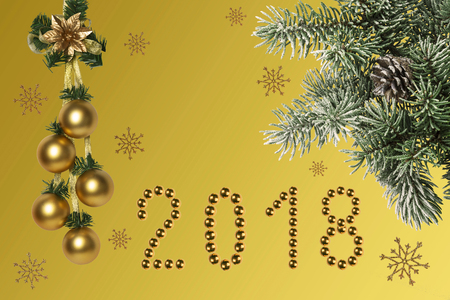 Christmas holidays composition on gold background with with a branch of spruce covered with snow and...