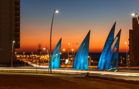 Sculptural group sails with changing colors at sunset in Ashdod, Israelのeditorial素材